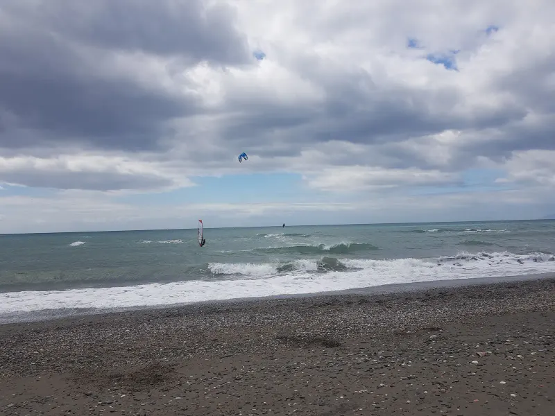 Cloudy sky over the sea and a dark sand beach on the Costa del Sol